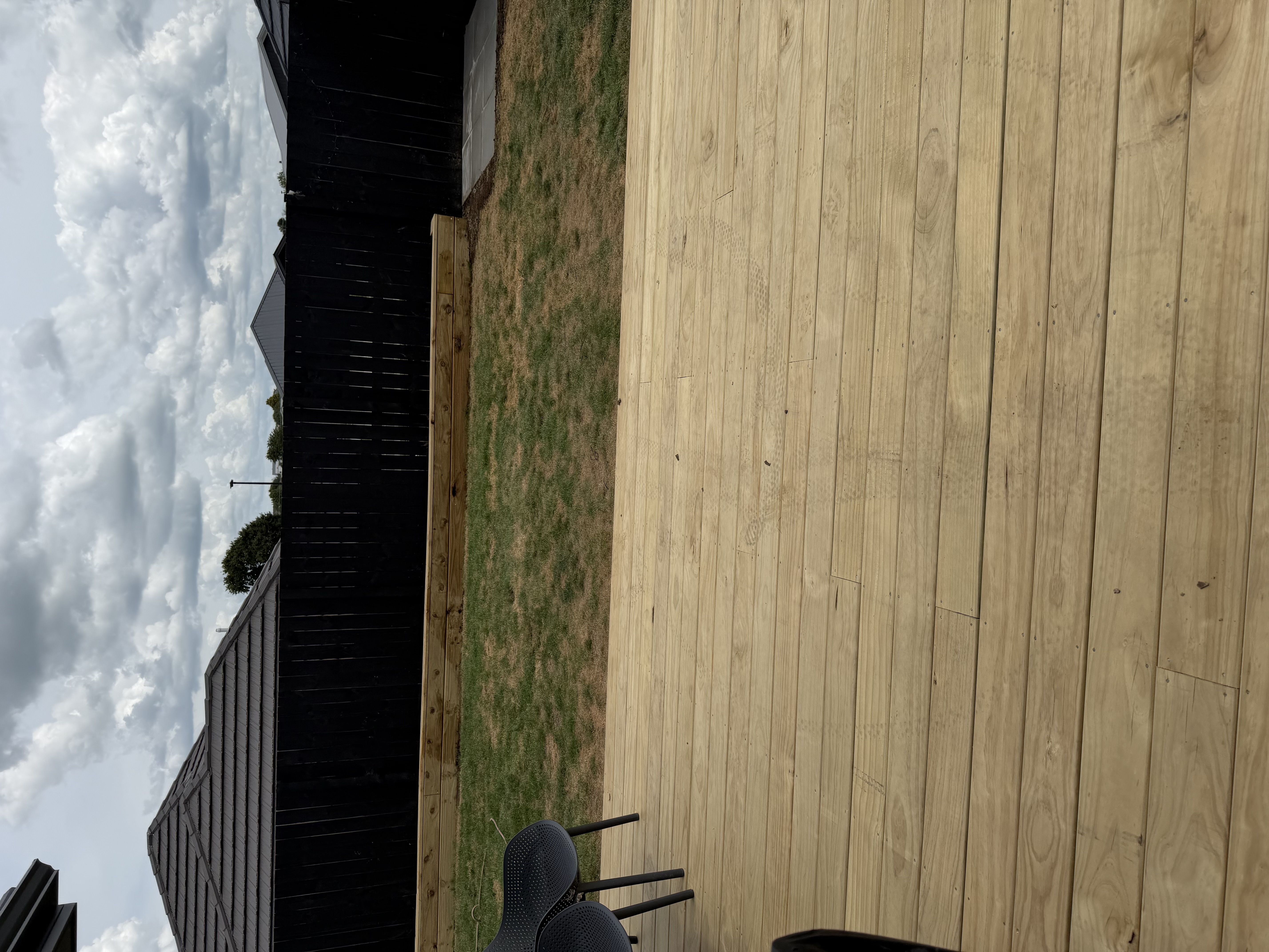 Timber deck with retaining wall and lawn — Element Landscaping Waikato