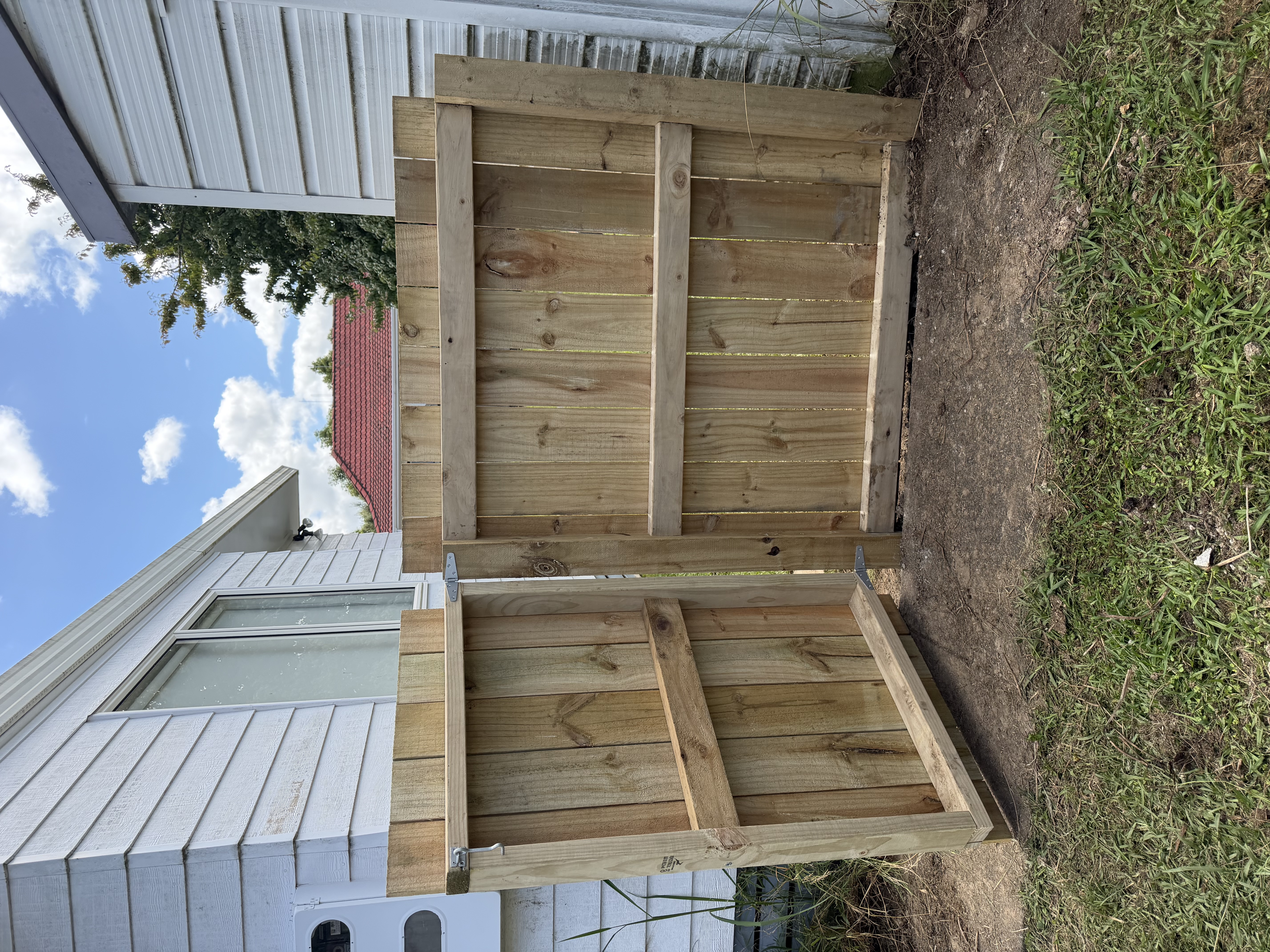 Timber double gate installation between houses — Element Landscaping Waikato